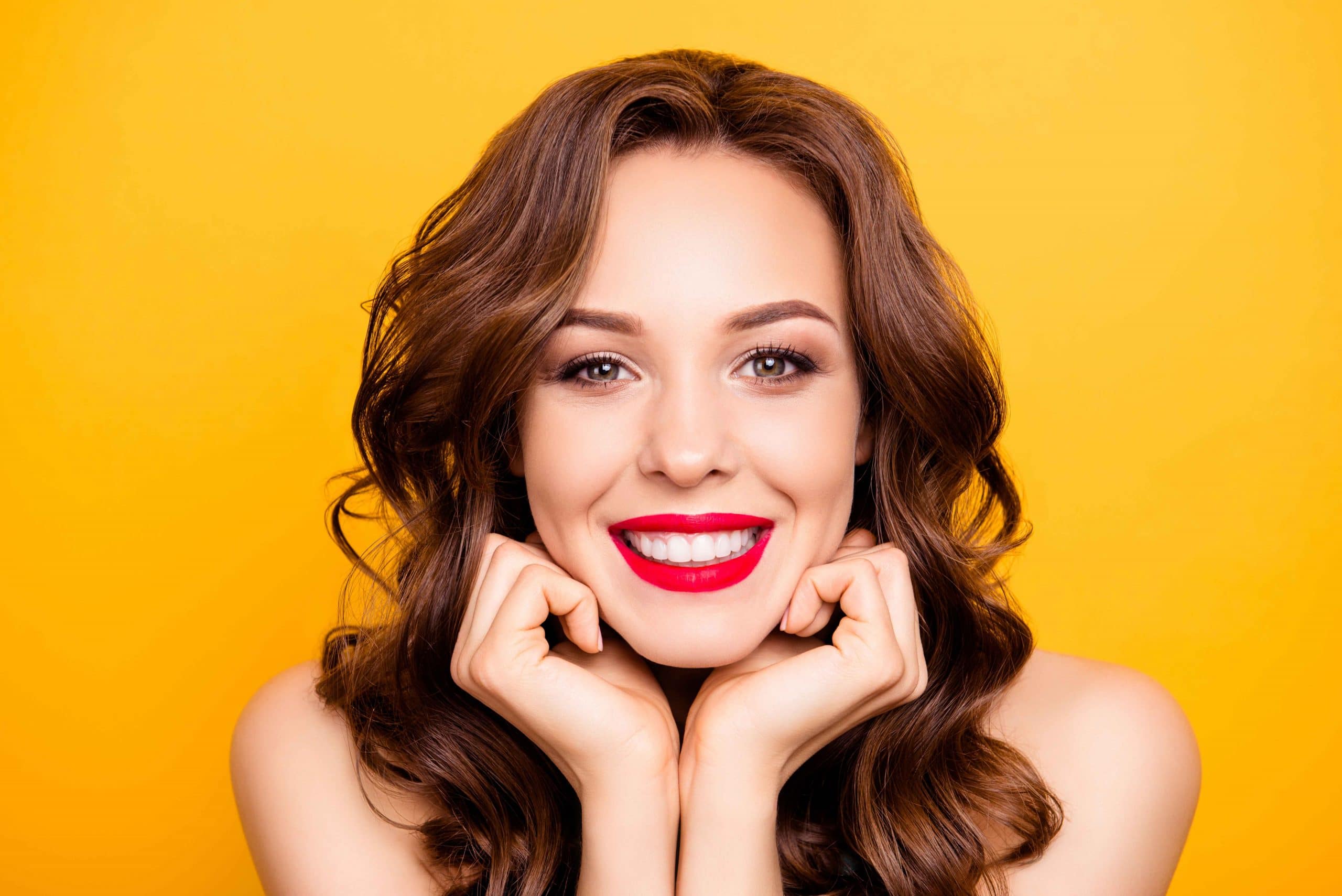 Closeup portrait of pretty elegant girl with straight white teeth modern hairstyle isolated on yellow background demonstrate perfect make up for event holiday birthday